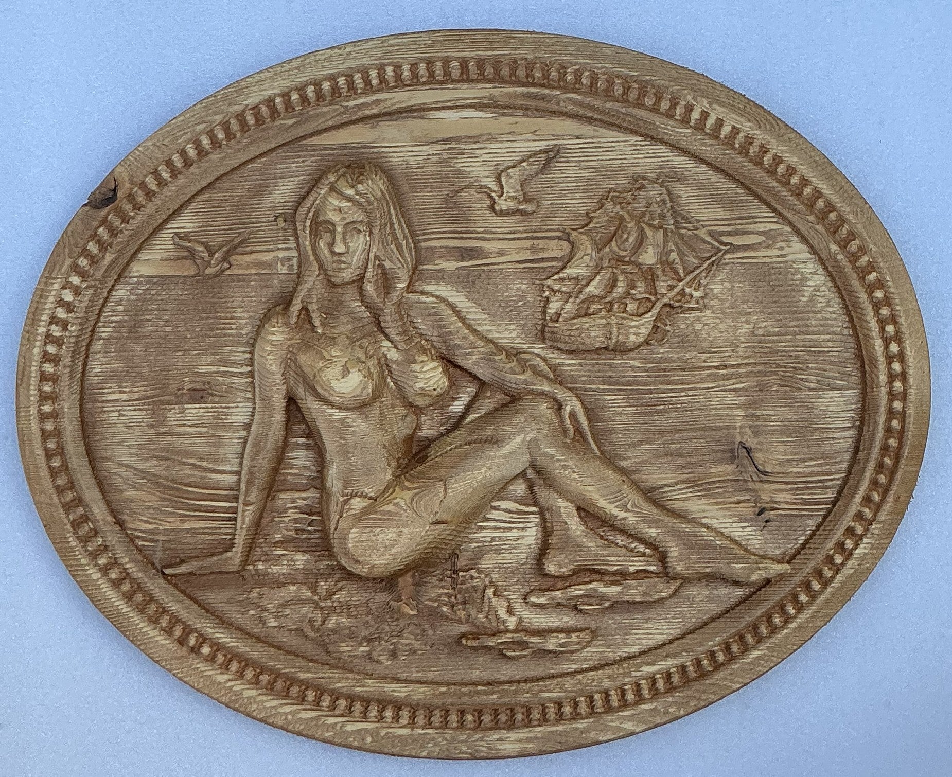 Wooden relief painting – woman by the sea with ship, oval frame